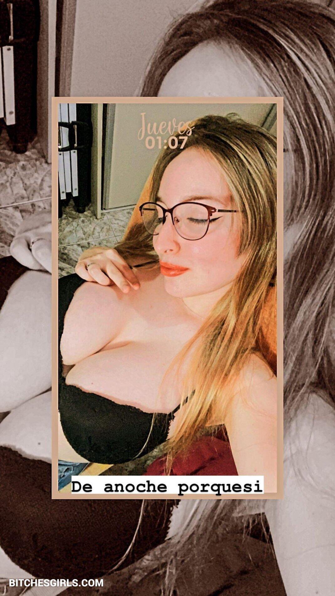 a woman in a revealing outfit confidently posing for the camera